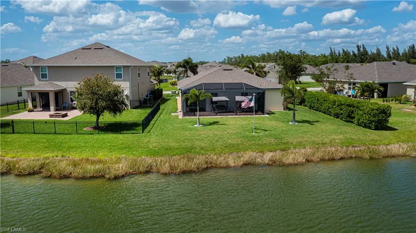 Rear view of house featuring a fenced backyard, a residential view, a lanai, and a patio
