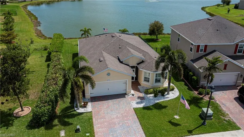 Drone / aerial view with a water view. Notice the privacy hedges and extra space on the left from neighbors!