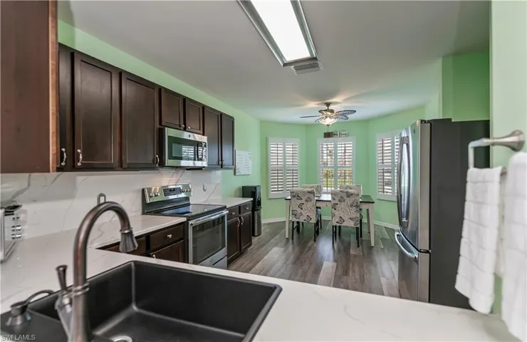 featuring FARMER STYLE Sink. View facing into kitchen from living area