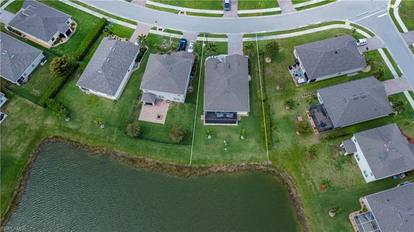 Birds eye view of property with a residential view and a water view