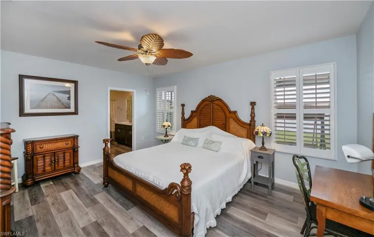Master Bedroom with connected bathroom, baseboards with LVP floors