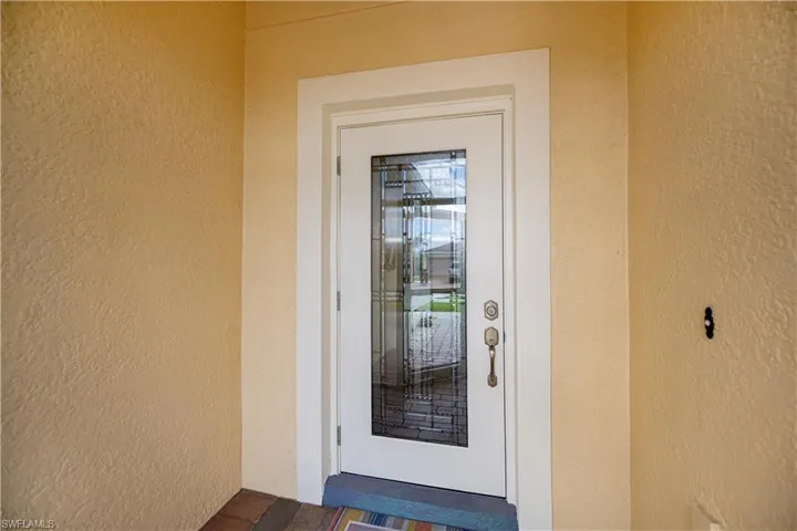 outward open 150 MPH wind impact door with beveled glass