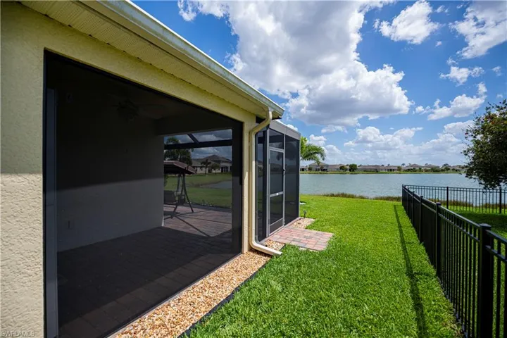 side view of yard, water and side of your screened in patio