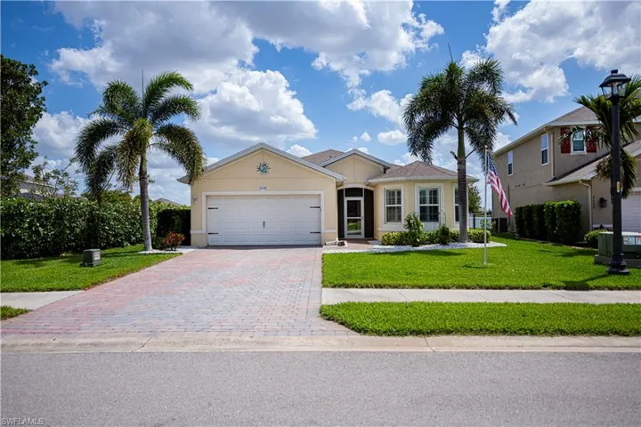 Ranch-style single story home with St. Augustine lawn and decorative curbing around the home