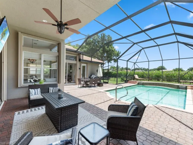 View of swimming pool with a patio, outdoor lounge area, and ceiling fan