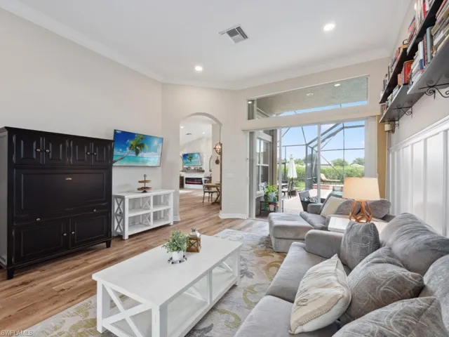 Living room featuring light wood-type flooring and ornamental molding