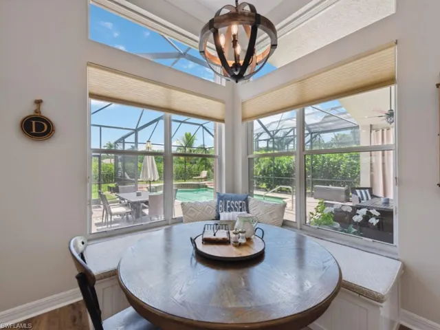 Breakfast nook featuring a notable chandelier, hardwood / wood-style flooring, and plenty of natural light