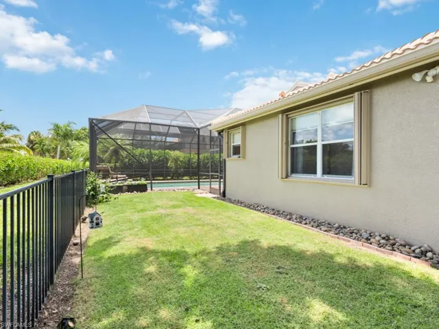 View of yard featuring a pool and screened enclosure