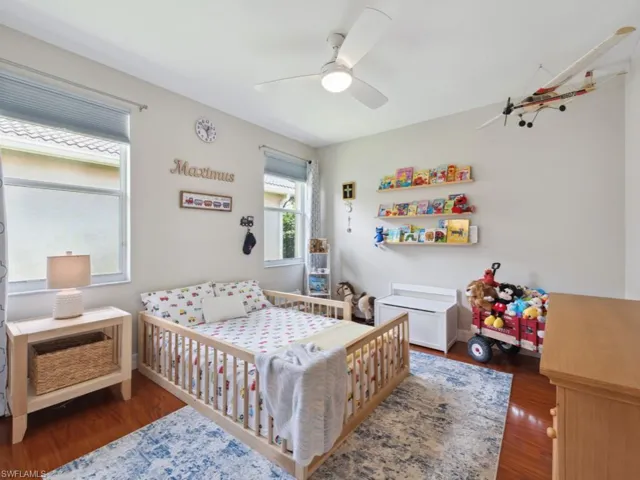 Bedroom featuring wood-type flooring and ceiling fan
