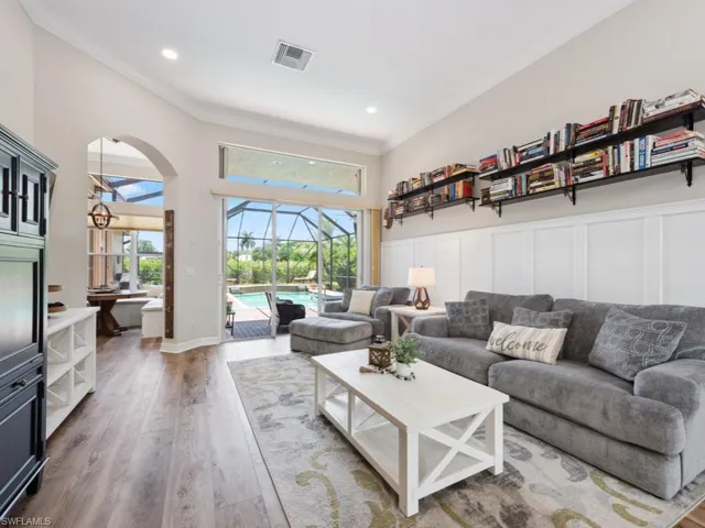 Living room featuring crown molding and wood-type flooring