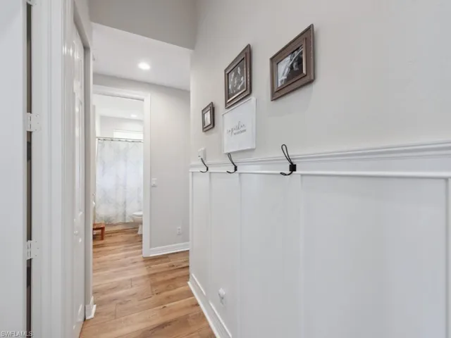 Hallway with light hardwood / wood-style flooring