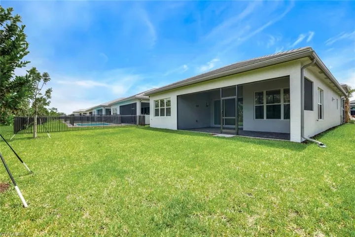 Back of property with a yard