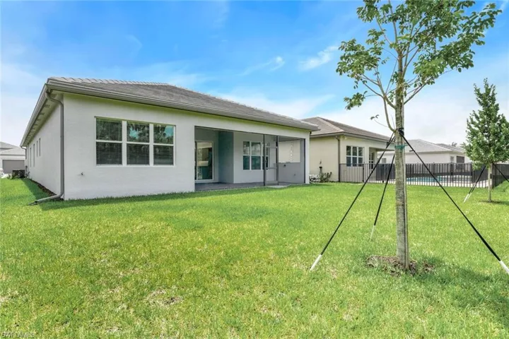 Back of house featuring a lawn
