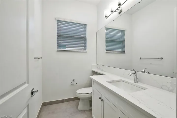 Bathroom with tile floors, toilet, and vanity