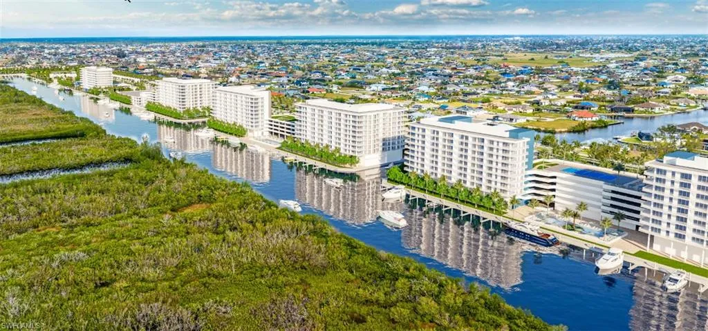 Birds eye view of property with a water view