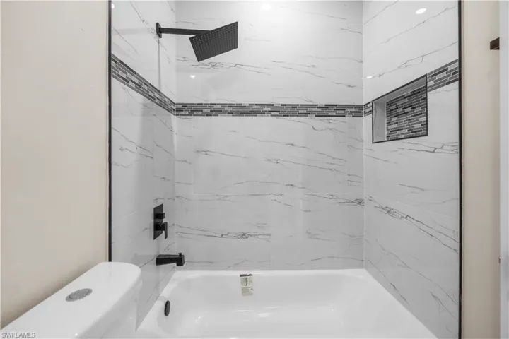 Full bathroom with bathtub / shower combination and toilet