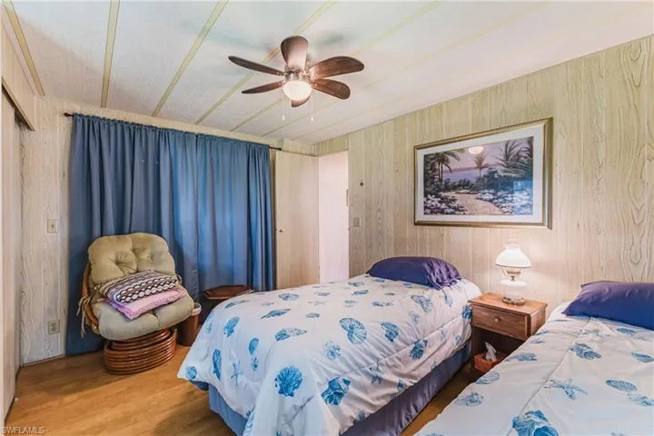 Wood-finish flooring with wood-paneled walls and ceiling