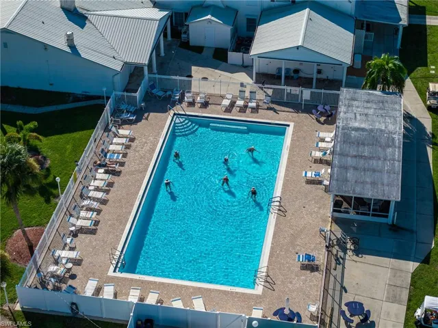 Rectangular swimming pool with integrated steps, surrounded by a paver deck