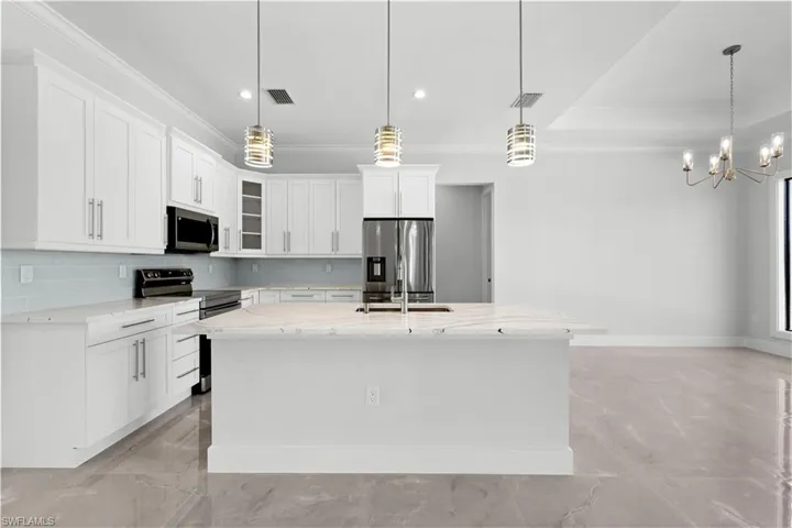 Kitchen with crown molding, appliances with stainless steel finishes, backsplash, light stone counters, and glass insert cabinets