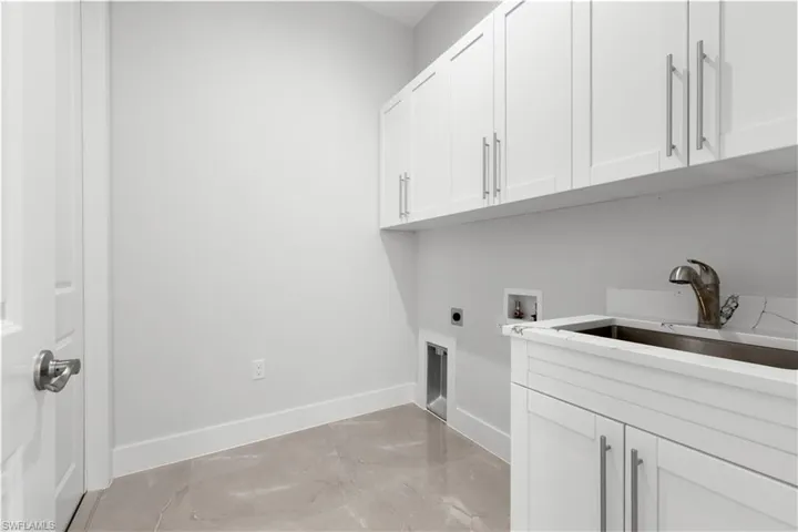 Laundry area featuring cabinet space, hookup for an electric dryer, and hookup for a washing machine