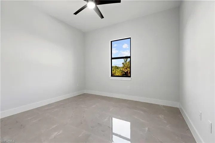 Unfurnished room featuring baseboards and a ceiling fan