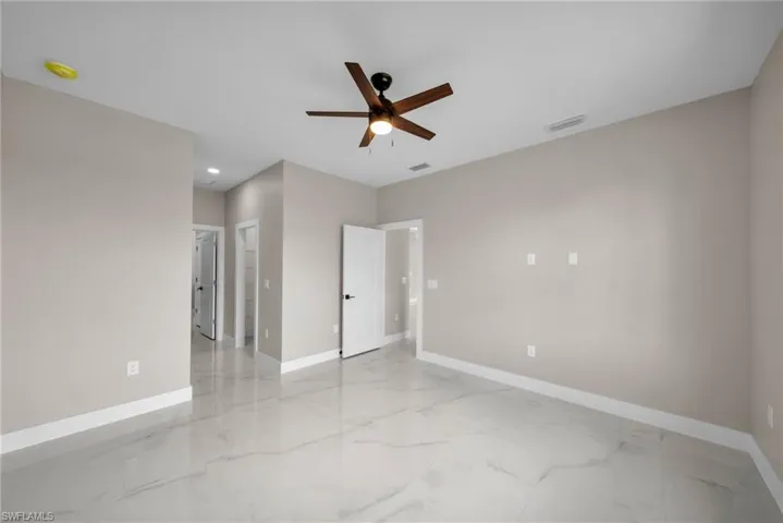 Unfurnished bedroom with light marble finish flooring, ceiling fan, and recessed lighting
