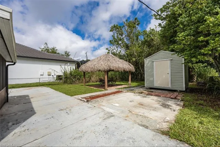 Back yard with tiki hut and storage shed, both with recent electricBack yard with updated tiki hut and shed, both with recent electric