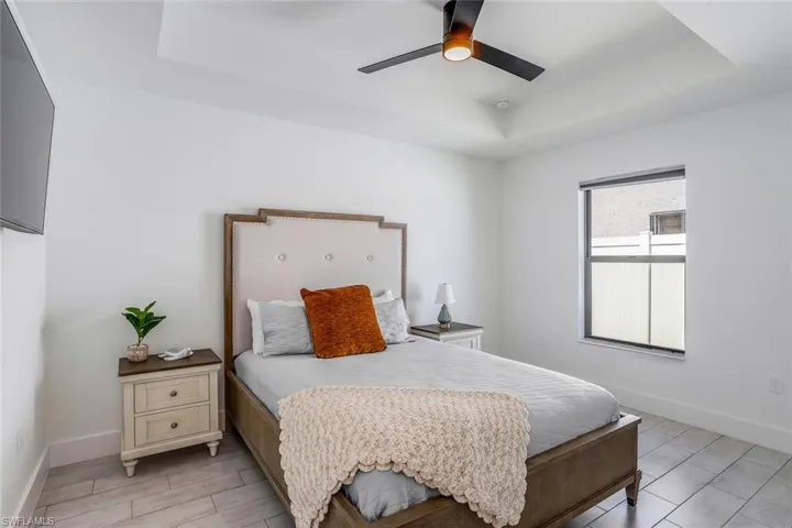 4th Guest bedroom with blackout shade for late riser or plenty of natural light. Recessed tray ceiling with a modern ceiling fan and recessed lighting