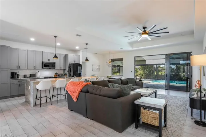 Open-concept living space with light-toned tile flooring throughout