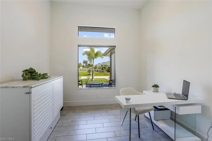 Bright open flex space doubling as office/formal dining with plenty of light.
