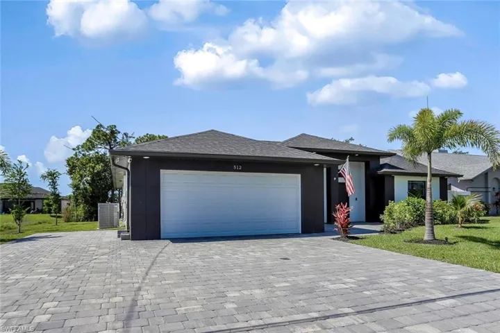 Contemporary single-story residence featuring a dark gray and white exterior