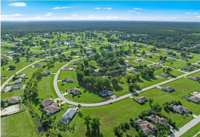 Aerial perspective of a sprawling residential area featuring numerous single-story homes on generously sized lots
