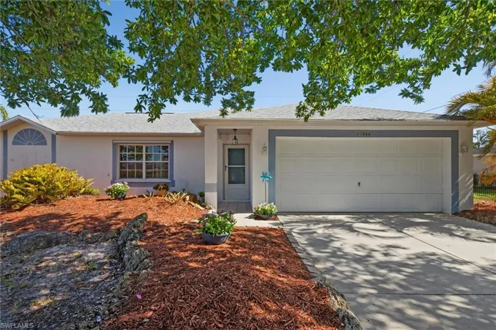 Single-story residence featuring a two-car garage and a paved driveway