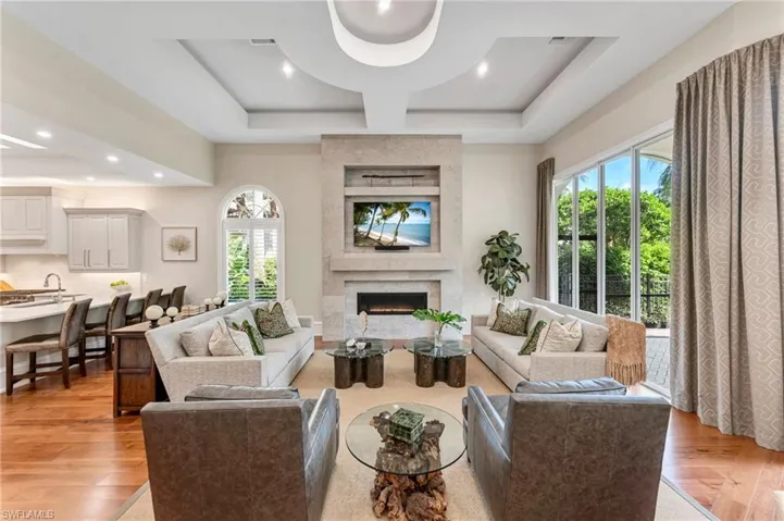 This residence is the epitome of quality and bespoke finishes. The completely re-imagined family room has a custom, floor-to-ceiling, limestone-tiled wall that encompasses a linear, gas fireplace, TV, and art niche.