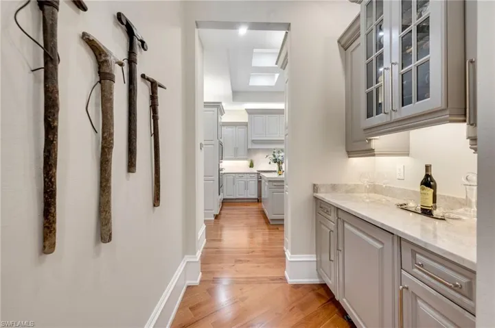 The Butler's pantry just off the kitchen could also serve as your coffee bar in the morning!  Updated cabinetry, complete with custom wine cabinet, wine refrigerator, and leathered, Taj Mahal counters.  Supremely beautifully crafted.