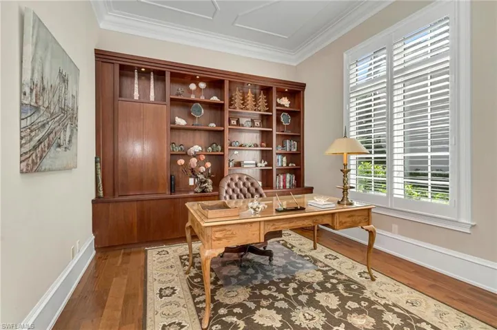 The office boasts of custom, bespoke cabinetry for abundant storage, 12-foot high ceilings, and new planation shutters.