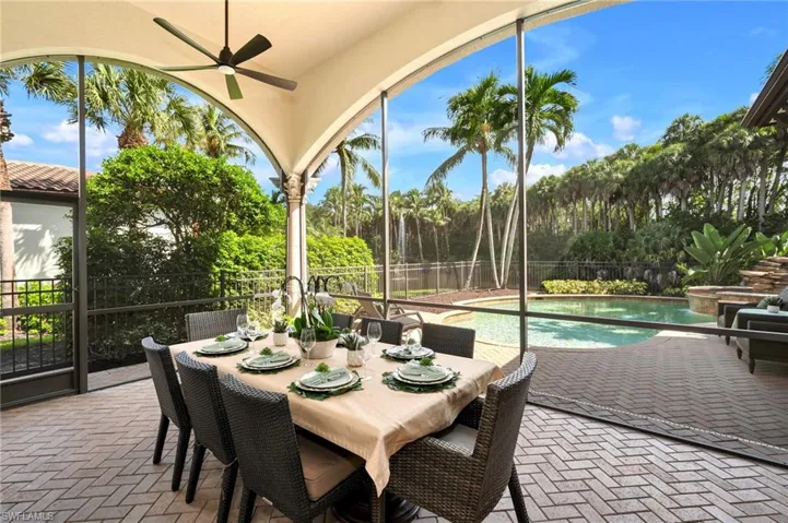 The screened-in lanai is perfect for al fresco dining, set amidst such tranquil views...