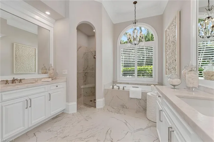 ...new plantation shutters, and the pièce de la résistance:  a French Baccarat crystal chandelier adorns the tub niche.  This luxurious, Spa-like bath beckons...