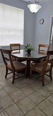 Dining space featuring light tile patterned floors