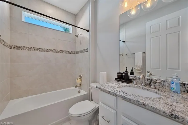 Full bath featuring shower / bath combination and vanity