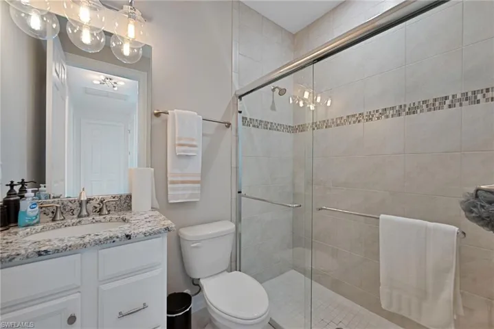 Bathroom with vanity and a stall shower