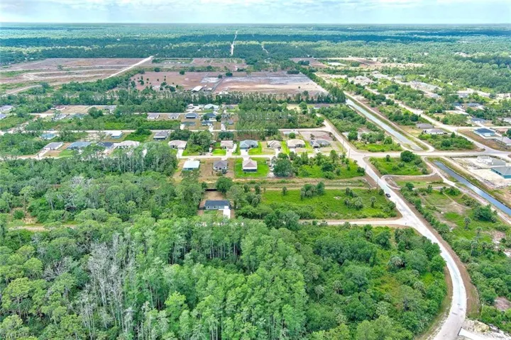 Aerial view of property's location featuring a forest