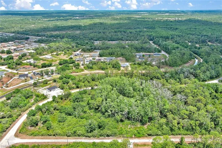 Aerial view of property's location with a forest