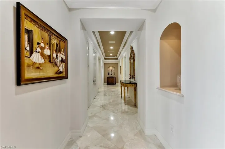 Wide marble lined hallways with lite art niches