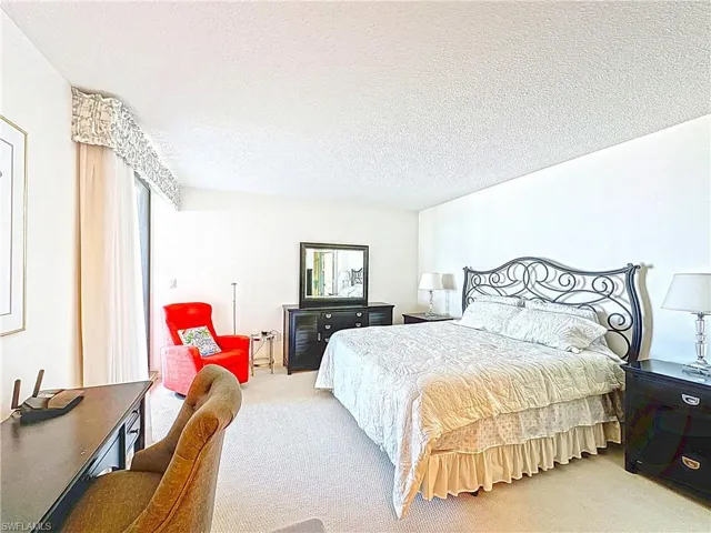 Carpeted bedroom featuring a textured ceiling