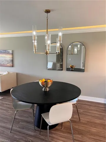 Dining area with ornamental molding and luxury vinyl tile floors