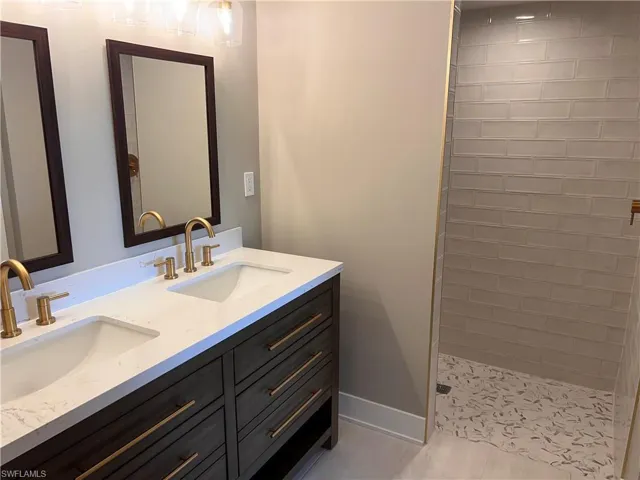 Primary Bathroom with double vanity and a walk in shower