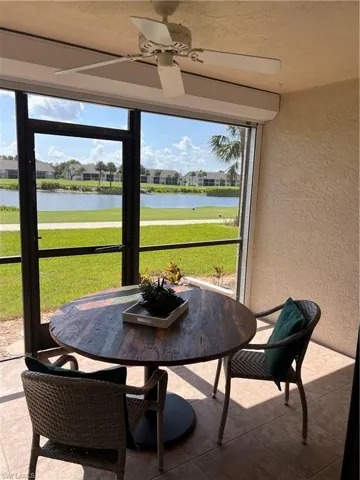 Back lanai with a ceiling fan and a water view