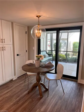 Breakfast nook with  luxury vinyl tile flooring, and a chandelier