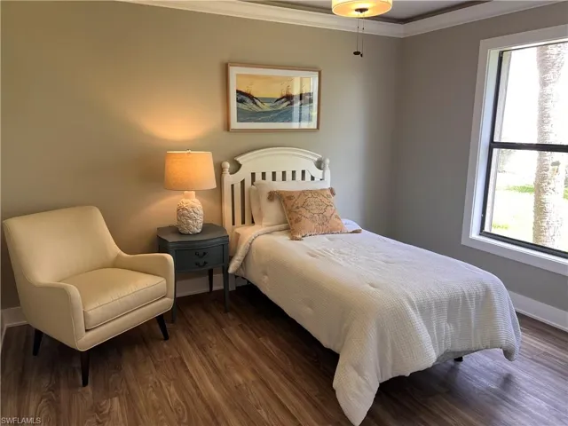 Bedroom 2 featuring crown molding and luxury vinyl tile flooring